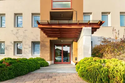 an entrance to a building with a red door at Bella Mura Golden Apartment in Moravske Toplice