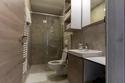 a bathroom with a toilet and a sink and a shower at B&B La Siesta in Markovci
