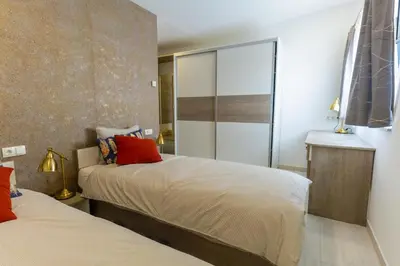 a bedroom with two beds and a sliding glass door at B&B La Siesta in Markovci