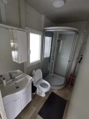 a bathroom with a sink and a toilet and a shower at Roof Apartment ART-PE in Trebnje