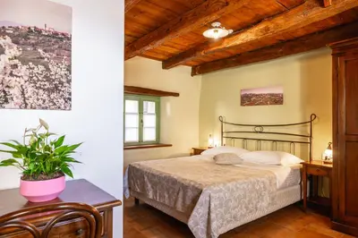 a bedroom with a bed and a wooden ceiling at House Marica in Šmartno