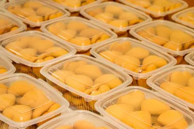 a group of plastic containers filled with yellow food at Tourist Farm Šalamun in Banovci
