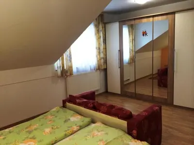 a bedroom with a bed and a mirror and a window at Tourist Farm Šalamun in Banovci