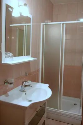 a bathroom with a sink and a shower at Penzion Letališče in Murska Sobota