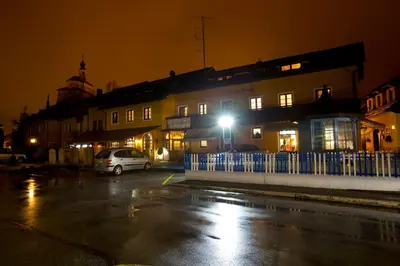 a building with a car parked in a parking lot at night at Guesthouse Špenko in Kamnik