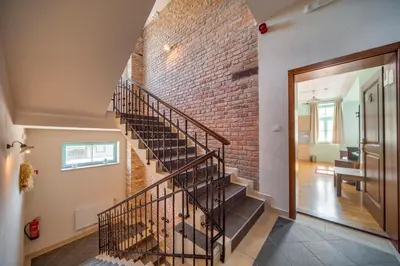 a brick wall and staircase in a house at Villa Parma in Maribor Self check - in in Maribor