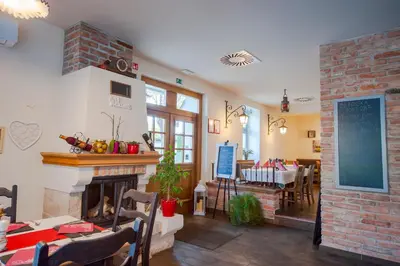 a living room with a fireplace and a dining room at Villa Parma in Maribor Self check - in in Maribor