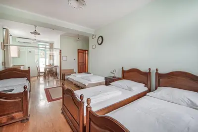 a bedroom with two beds and a dining room at Villa Parma in Maribor Self check - in in Maribor