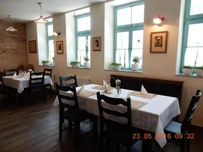 a dining room with tables and chairs and windows at Villa Parma in Maribor Self check - in in Maribor