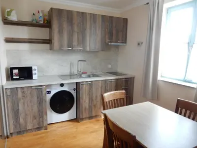 a kitchen with a sink and a washing machine at Villa Parma in Maribor Self check - in in Maribor