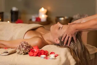 a woman getting a massage at a spa at Ortenia Apartments in Nature in Podčetrtek
