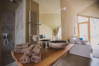 a bathroom with a sink and a counter with towels at Ortenia Apartments in Nature in Podčetrtek
