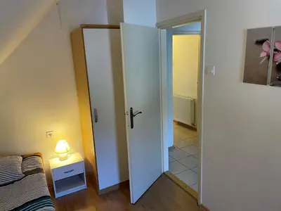 a bedroom with a white door next to a bed at Martinov dom in Kranjska Gora