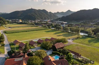 an aerial view of a village with mountains in the background at Martinova izba - Family Bungalows in Laško