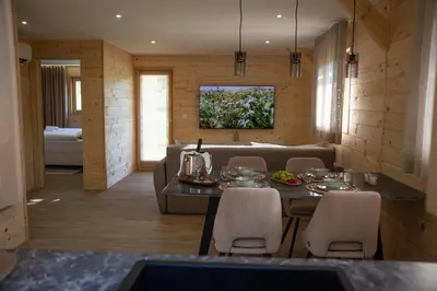 a living room with a table and a couch at Martinova izba - Family Bungalows in Laško