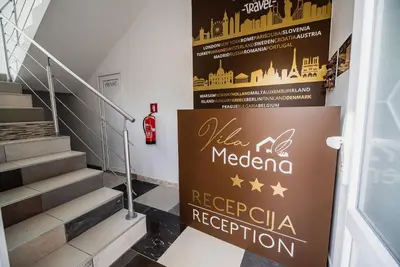 a stairway with a sign that reads melbourne reggae reception at Rooms Vila Medena in Brežice