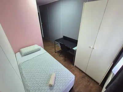a small room with a bed and a desk at Hostel M in Maribor