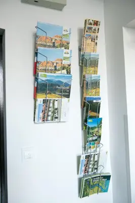 a wall with posters and skis on a wall at Hostel M in Maribor