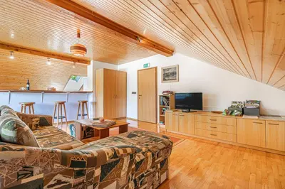 a living room with a couch and a television at House Mavko Near Lake Cerknica - Happy Rentals in Grahovo