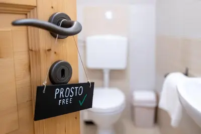 a bathroom with a toilet and a sign on a door at Chalet Pr Dobravc in Bohinj