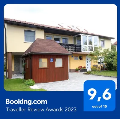 a house with a red garage in front of it at Apartma Vila Zigmund in Cerknica