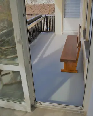 a screened porch with a bench and a door at Apartma Vila Zigmund in Cerknica