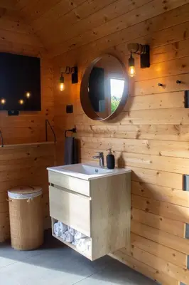 a bathroom with a sink and a mirror at Hiška-Glamping in Ajdovščina