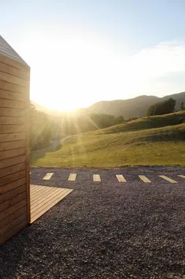 a room with a view of a field and a building at Hiška-Glamping in Ajdovščina