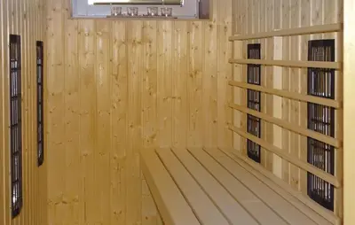a room with a wooden wall with two shelves at Apartmaji Čujež in Rečica ob Savinji