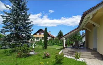 a backyard with a house and a tree at Apartmaji Čujež in Rečica ob Savinji