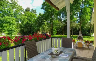a patio with a table and chairs and flowers at Apartmaji Čujež in Rečica ob Savinji