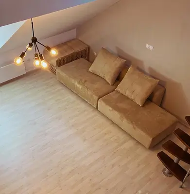 a living room with a couch and a chandelier at Apartment 31 Vila Golf Nice Vacation in Rogaška Slatina