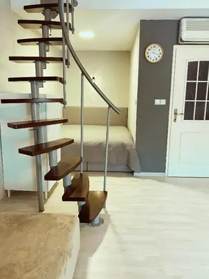 a spiral staircase in a room with a bedroom at Apartment 31 Vila Golf Nice Vacation in Rogaška Slatina
