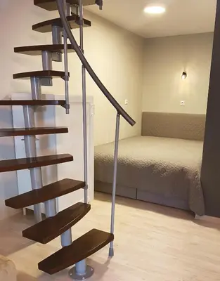a spiral staircase in a room with a bed at Apartment 31 Vila Golf Nice Vacation in Rogaška Slatina