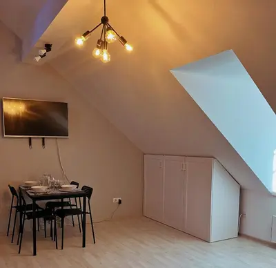a dining room with a table and a large window at Apartment 31 Vila Golf Nice Vacation in Rogaška Slatina