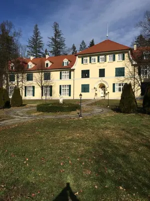 a large yellow building with a red roof at Apartment 31 Vila Golf Nice Vacation in Rogaška Slatina