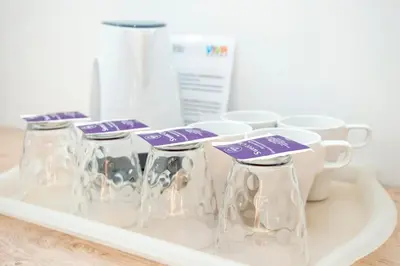 a tray with several wine glasses and cups on it at Viva Rooms in Ljubljana