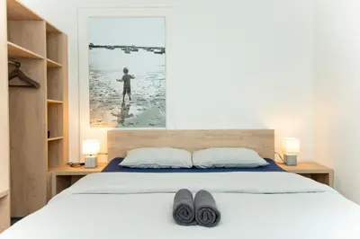 a bedroom with a bed with two shoes on it at Viva Rooms in Ljubljana