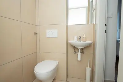 a bathroom with a toilet and a sink at Viva Rooms in Ljubljana