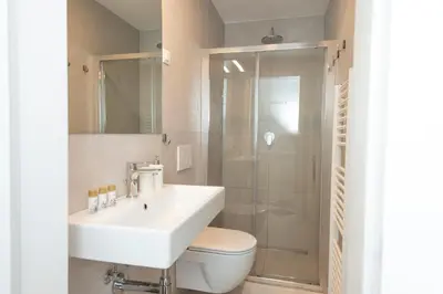 a bathroom with a toilet and a sink and a shower at Viva Rooms in Ljubljana