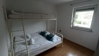 a bedroom with a bunk bed and a window at Apartma Apollonio in Črni Kal