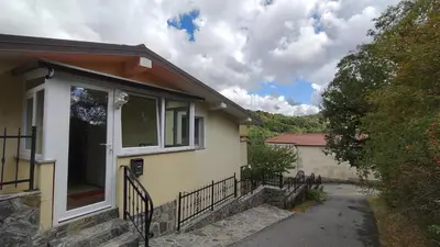 a yellow house with a window and a fence at Apartma Apollonio in Črni Kal