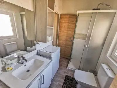 a bathroom with a sink and a toilet and a shower at Three Stars Luxury House ART-PE with pool and SPA pool in Trebnje
