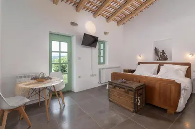 a bedroom with a bed and a table and chairs at Pool & Sauna Villa Gizela - Happy Rentals in Kojsko