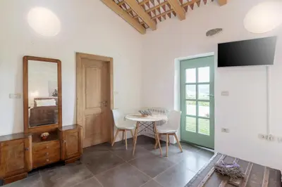 a dining room with a table and a mirror at Pool & Sauna Villa Gizela - Happy Rentals in Kojsko