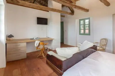 a bedroom with a bed and a desk and a chair at Pool & Sauna Villa Gizela - Happy Rentals in Kojsko