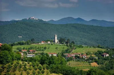 a small village on a hill with mountains in the background at Pool & Sauna Villa Gizela - Happy Rentals in Kojsko