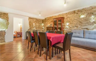a dining room with a red table and chairs at 3 Bedroom Pet Friendly Home In Col in Zoll