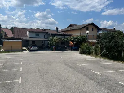 an empty parking lot in front of a house at Room Oaza Miru in Maribor