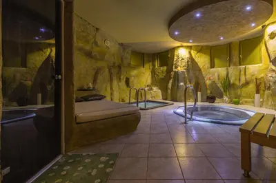 a large bathroom with two tubs in a room at Room Oaza Miru in Maribor